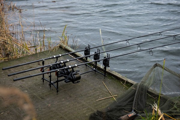 Carp Fishing Rods On Rod Pod On Wood Platform At Lake Stock Photo